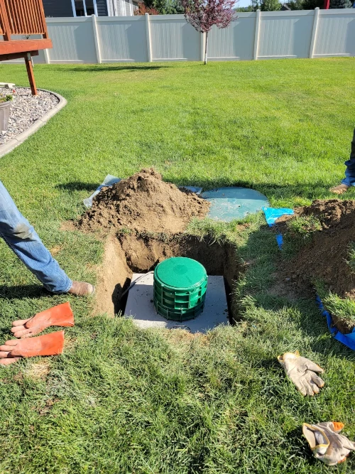 Septic tank riser lid in residential lawn.